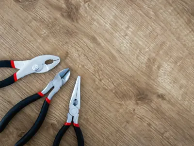 Pliers on a wooden floor